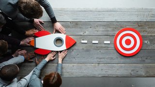 Business people with rocket