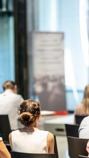 Male business speaker giving a talk at business conference event.