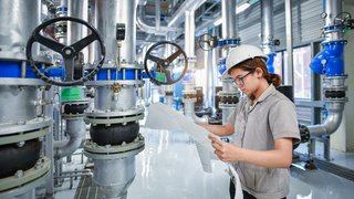 Young,Woman,Mechanical,Engineer,Holding,Drawing,To,Checking,And,Inspection