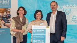 Die Blumengalerie Beate Matthäus in Herzogenaurach ist vom Bayerischen Wirtschaftsministerium als „Digitale Champions im Handel“ 2026 ausgezeichnet worden. Auf dem Foto: Michaela Pichlbauer (Günther Rid Stiftung für den bayerischen Einzelhandel), Inhaberin Beate Matthäus und Bayerns Wirtschaftsminister Hubert Aiwanger (von links)
