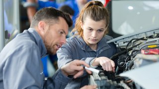 Frau als Mechanikerin in einer Autowerkstatt