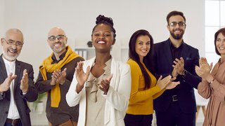 Diverse team of happy positive business men and women applauding you and smiling