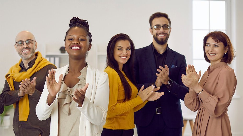 Diverse team of happy positive business men and women applauding you and smiling