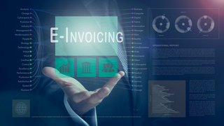 Businessman outreached hand holding a E-Invoicing business concept on a computerised screen display.