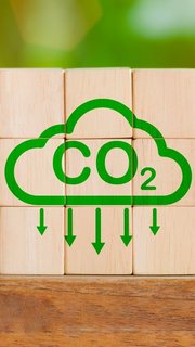 Reduce Co2 Emissions concept. Carbon reduction icon on wooden cube for decrease CO2. Carbon neutral, Net Zero, Climate change, Sustainable energy, Carbon footprint, environmental problems, neutrality,