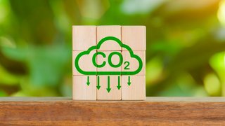 Reduce Co2 Emissions concept. Carbon reduction icon on wooden cube for decrease CO2. Carbon neutral, Net Zero, Climate change, Sustainable energy, Carbon footprint, environmental problems, neutrality,